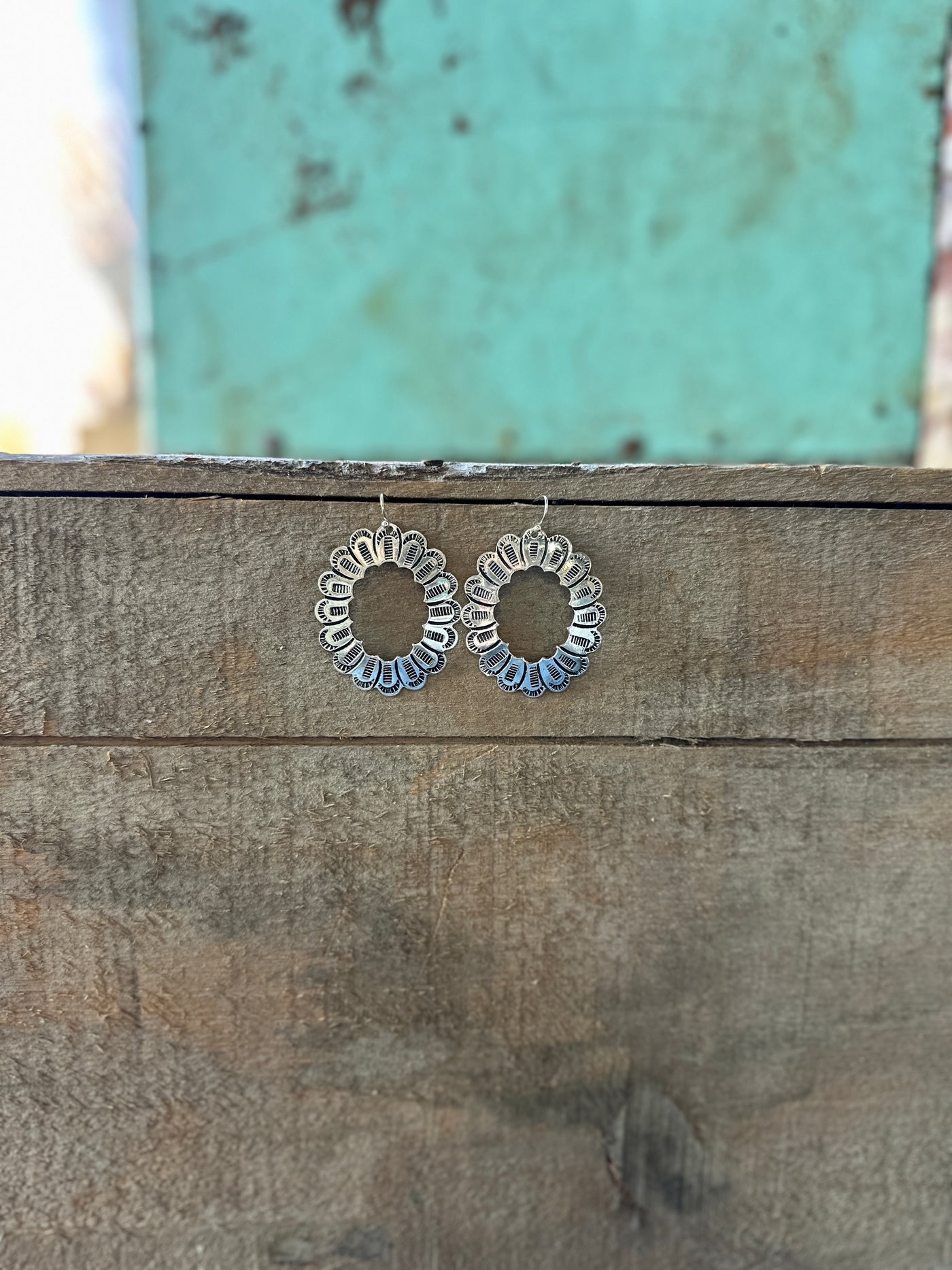 Picture of hanging Believer Silver Concho Earrings.