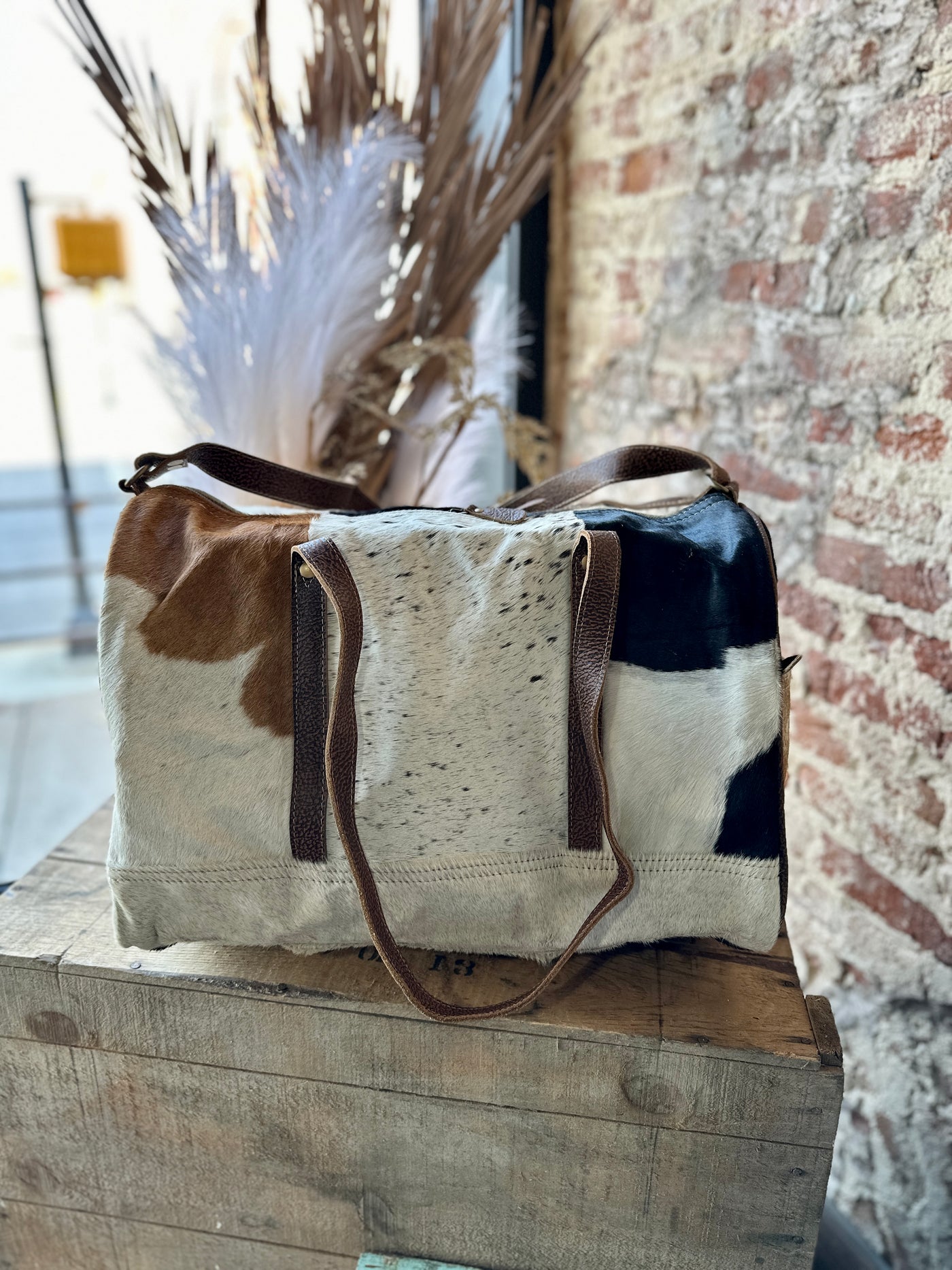 Side view picture of our Sigmund Cowhide & Leather Weekender Bag.