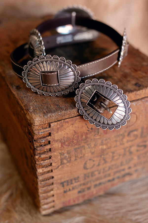 A close up of the Adalaide Genuine Leather & Concho Belt showing the unique starburst oval design of the conchos.