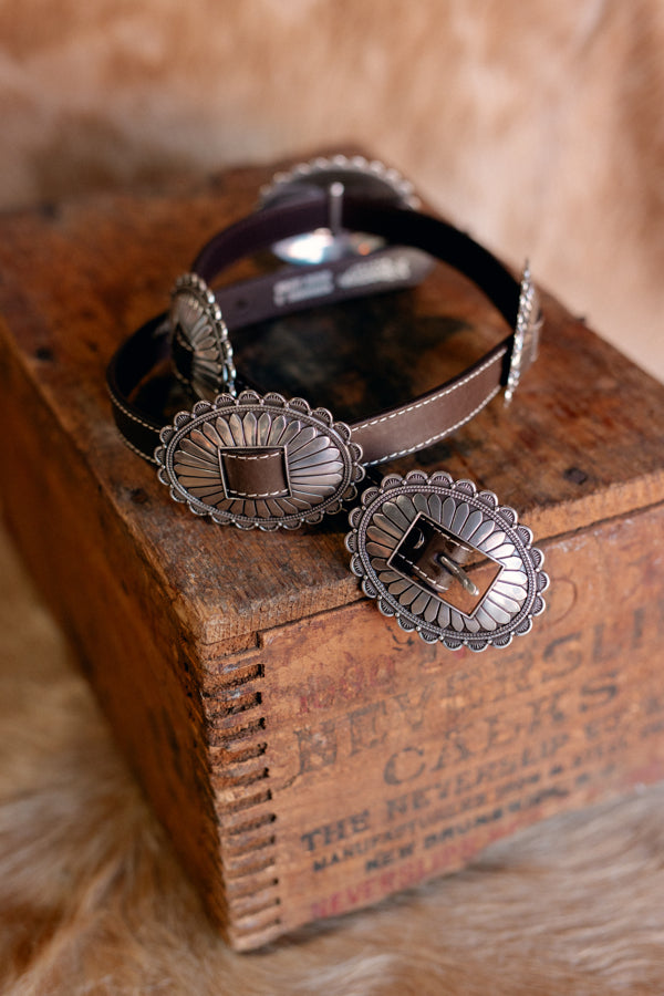 Adalaide Genuine Leather & Concho Belt featuring a genuine leather strap in brown and large oval floral silver conchos.