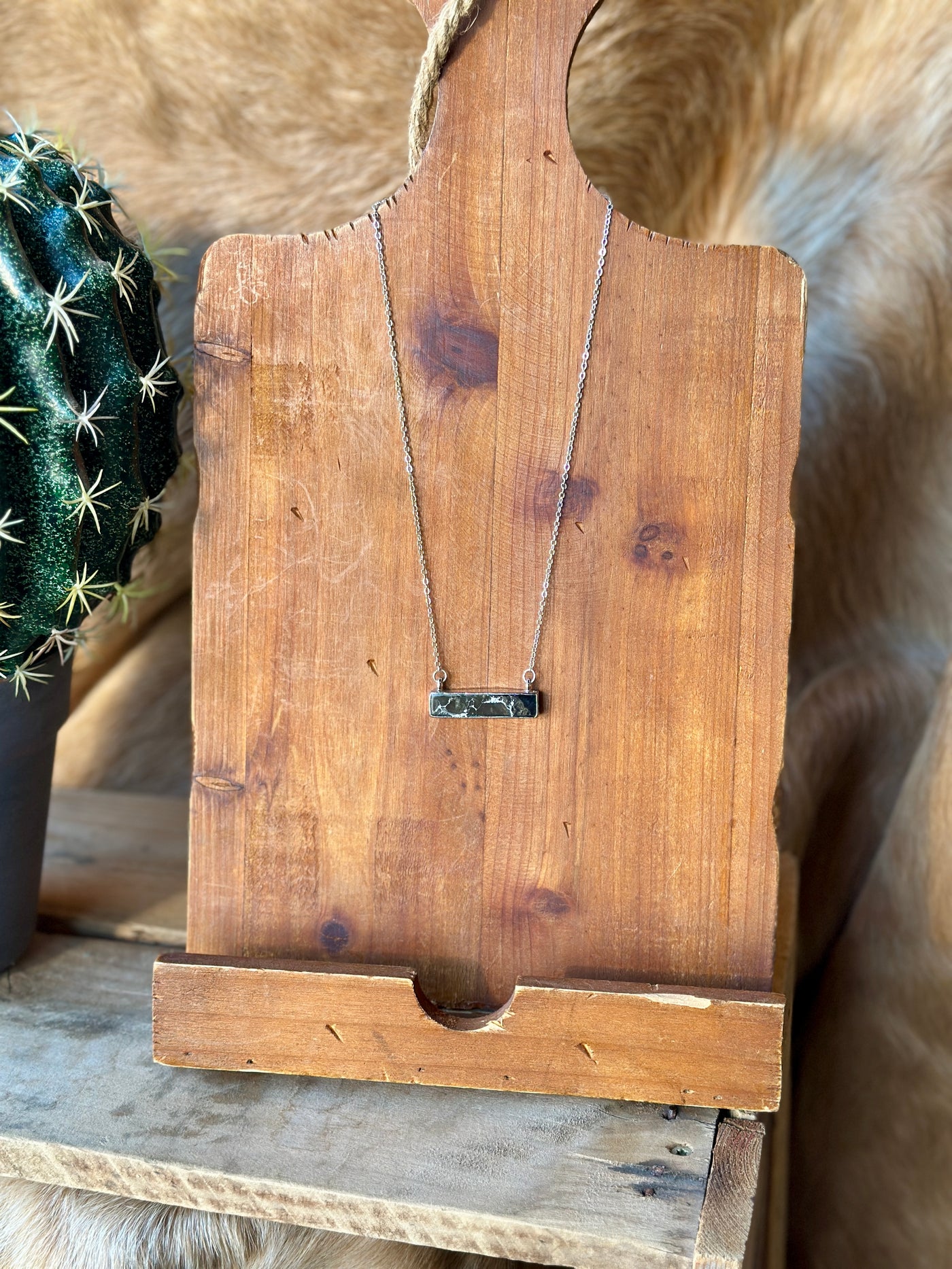 Silver and black stone Western necklace with versatile chain length.