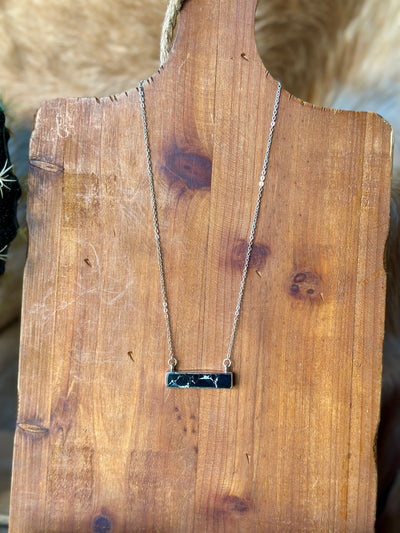 Western-inspired black stone bar necklace with silver clasp.