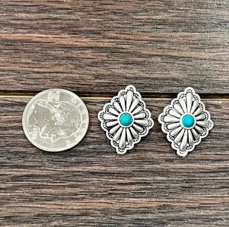 Stock photo of our Allison Silver Concho Earrings next to a quarter for a size reference.