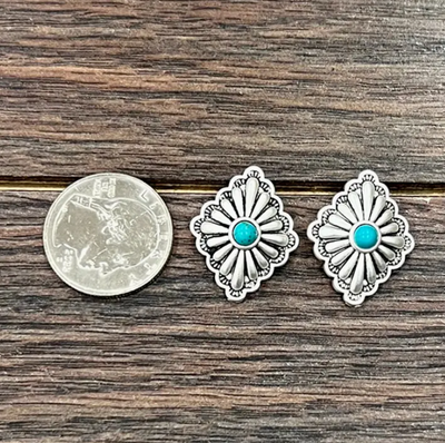 Stock photo of our Allison Silver Concho Earrings next to a quarter for a size reference.