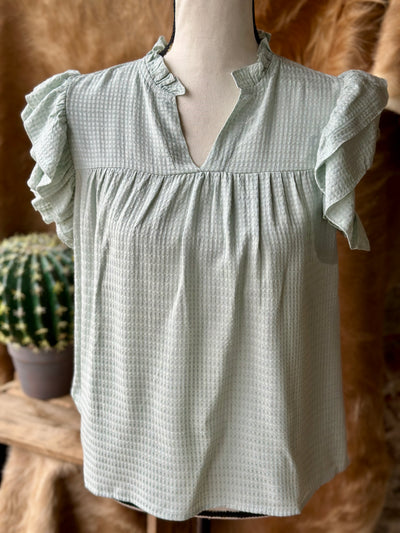 Soft and breathable sage blouse with flowy silhouette.