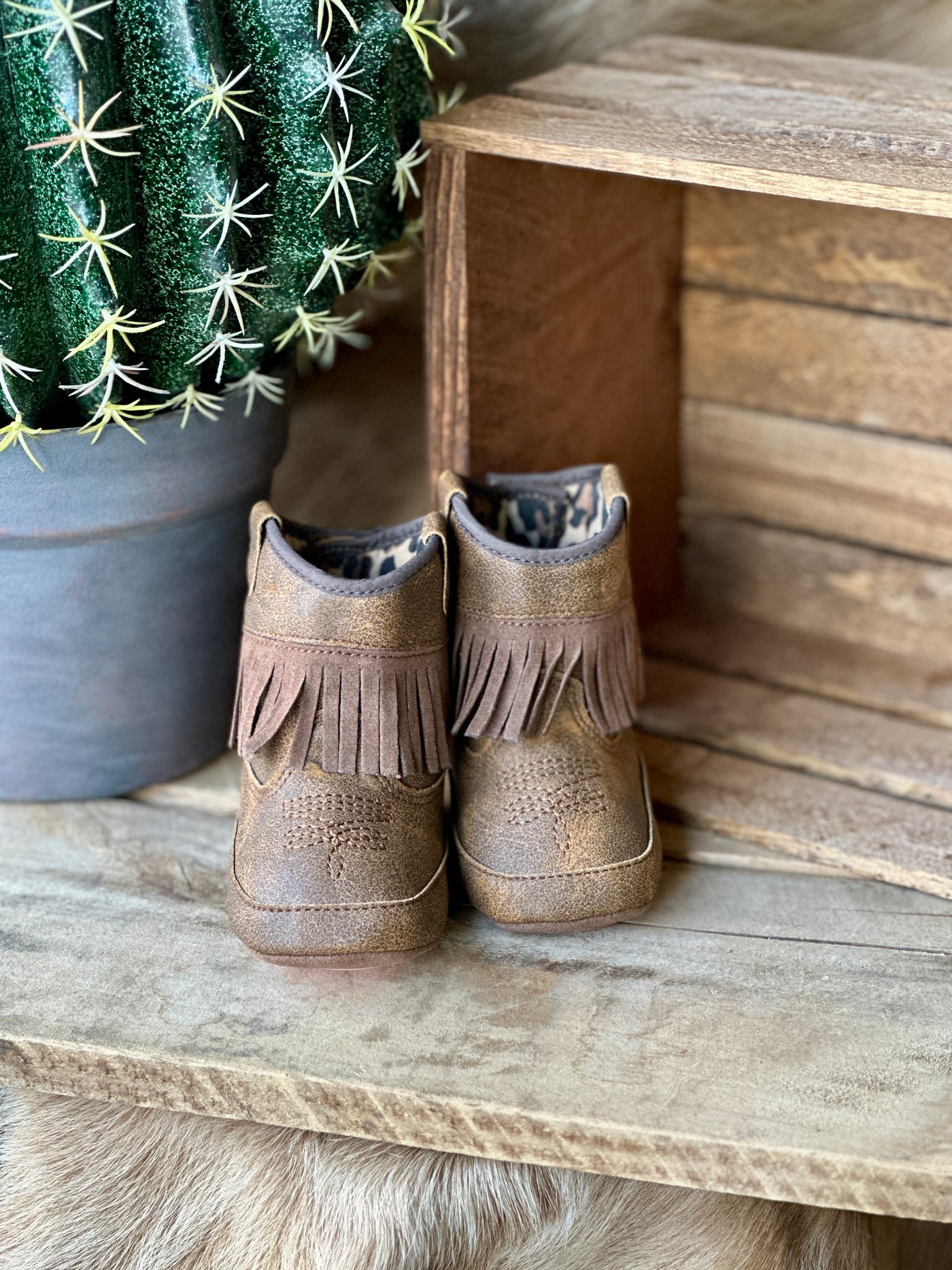 Lightweight Western-inspired baby boots with grip and stability.