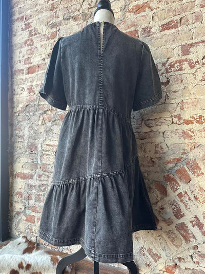 Mineral washed denim dress with a relaxed fit and 100% cotton material displayed on a mannequin.