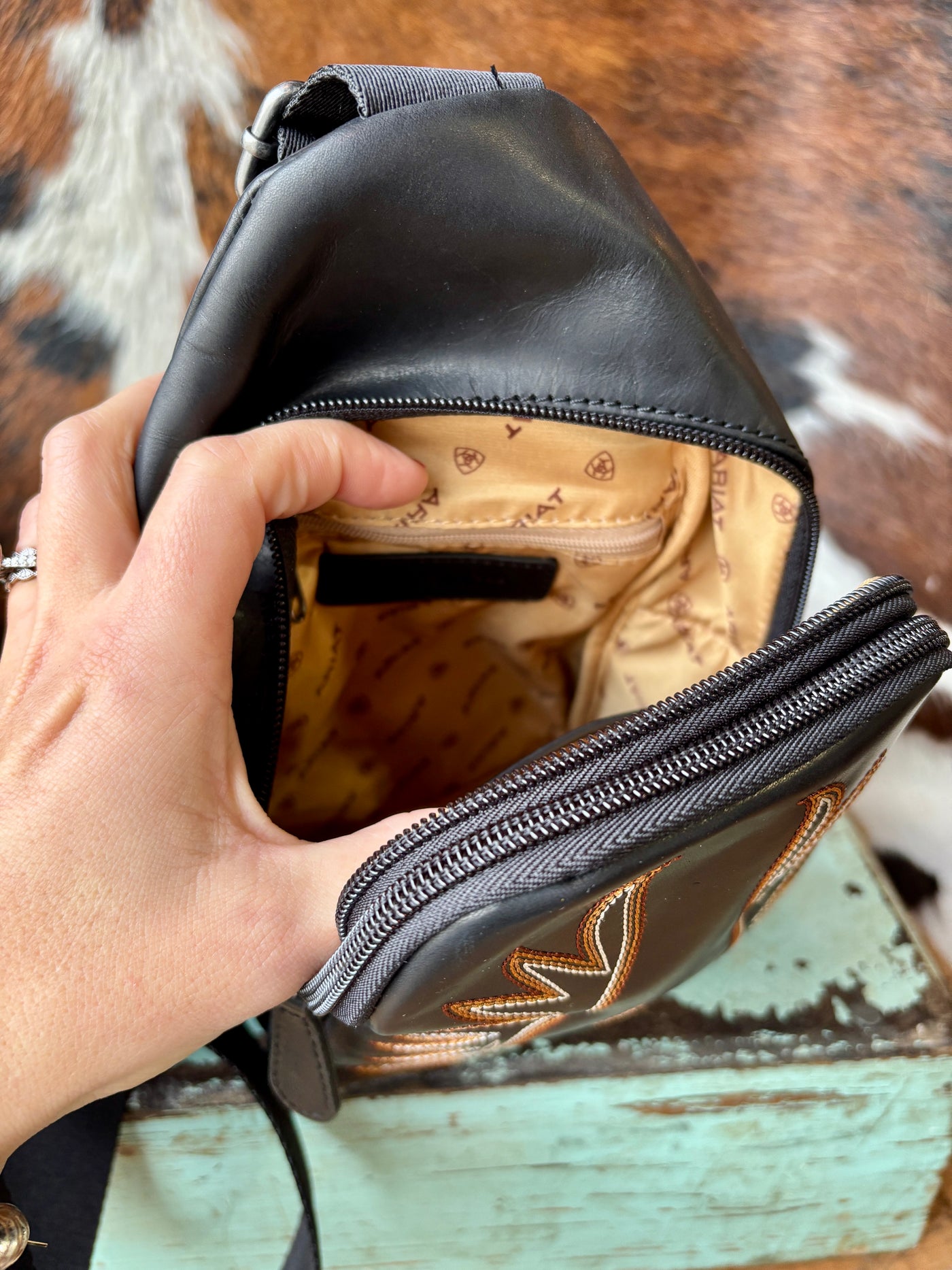 The Ariat branded lining inside the Ariat Casanova Sling Bag [Black] is incredibly elegant.