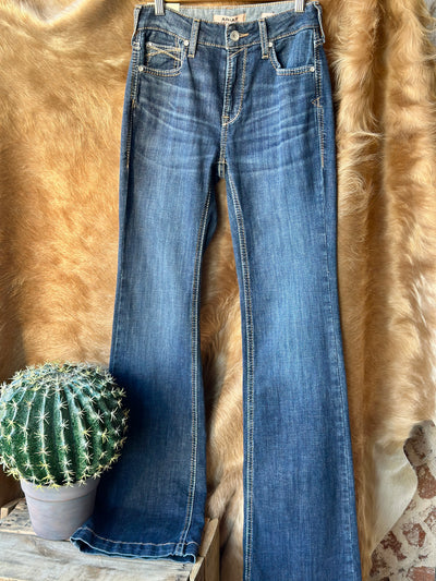 Broker Leather's Ariat High Rise Kimber Slim Trouser Jeans displayed in a Western background showing waist, stitching, and trouser cuff.