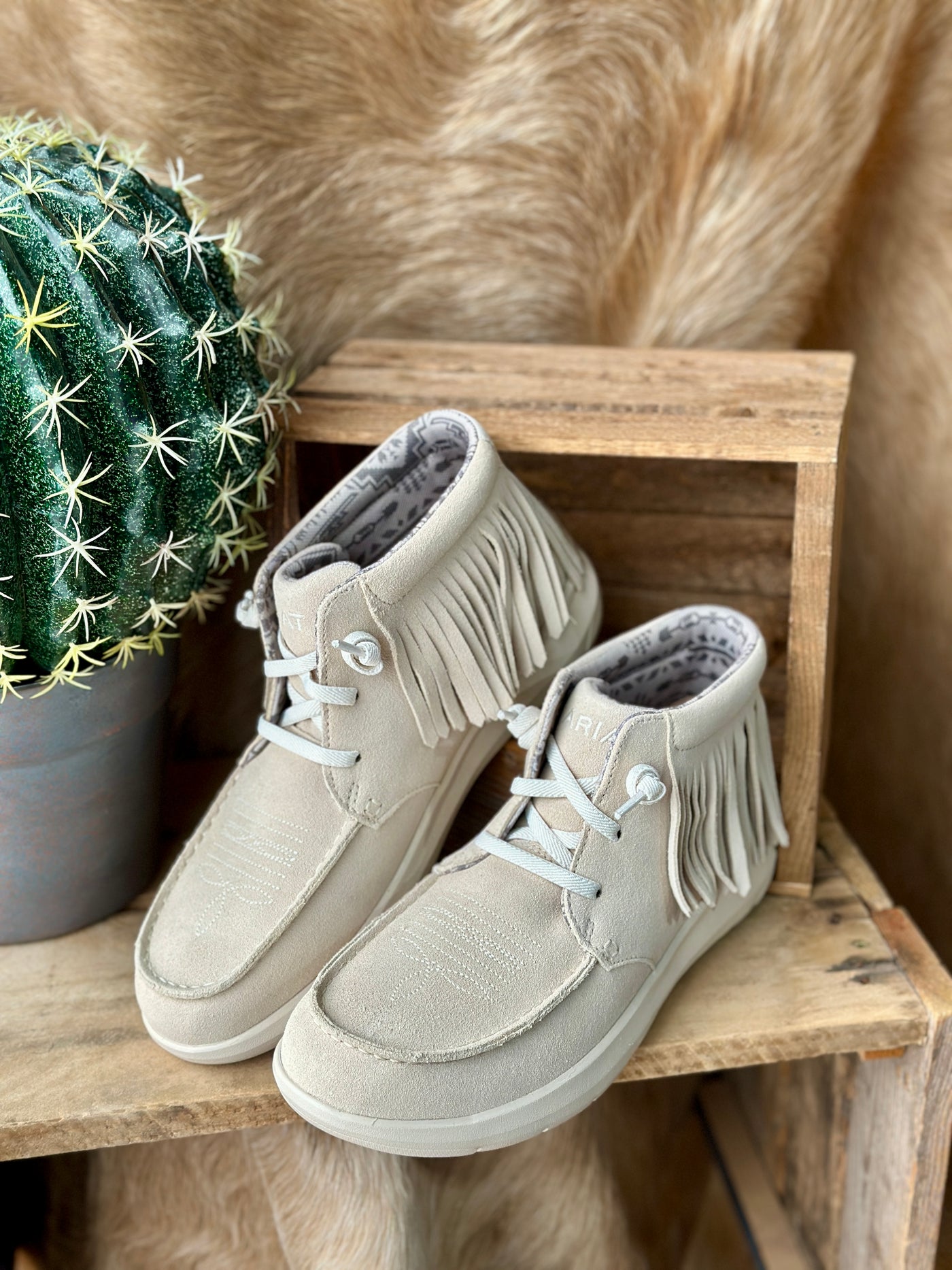 Ariat Hilo High Top Fringe Slip-On Shoe in Sand Suede with Western-inspired fringe and moc toe.