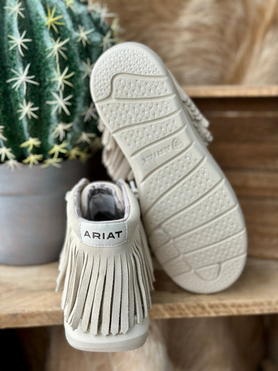 Flat lay of Ariat Hilo High Top Fringe Slip-On Shoes with denim and accessories for a casual cowgirl look