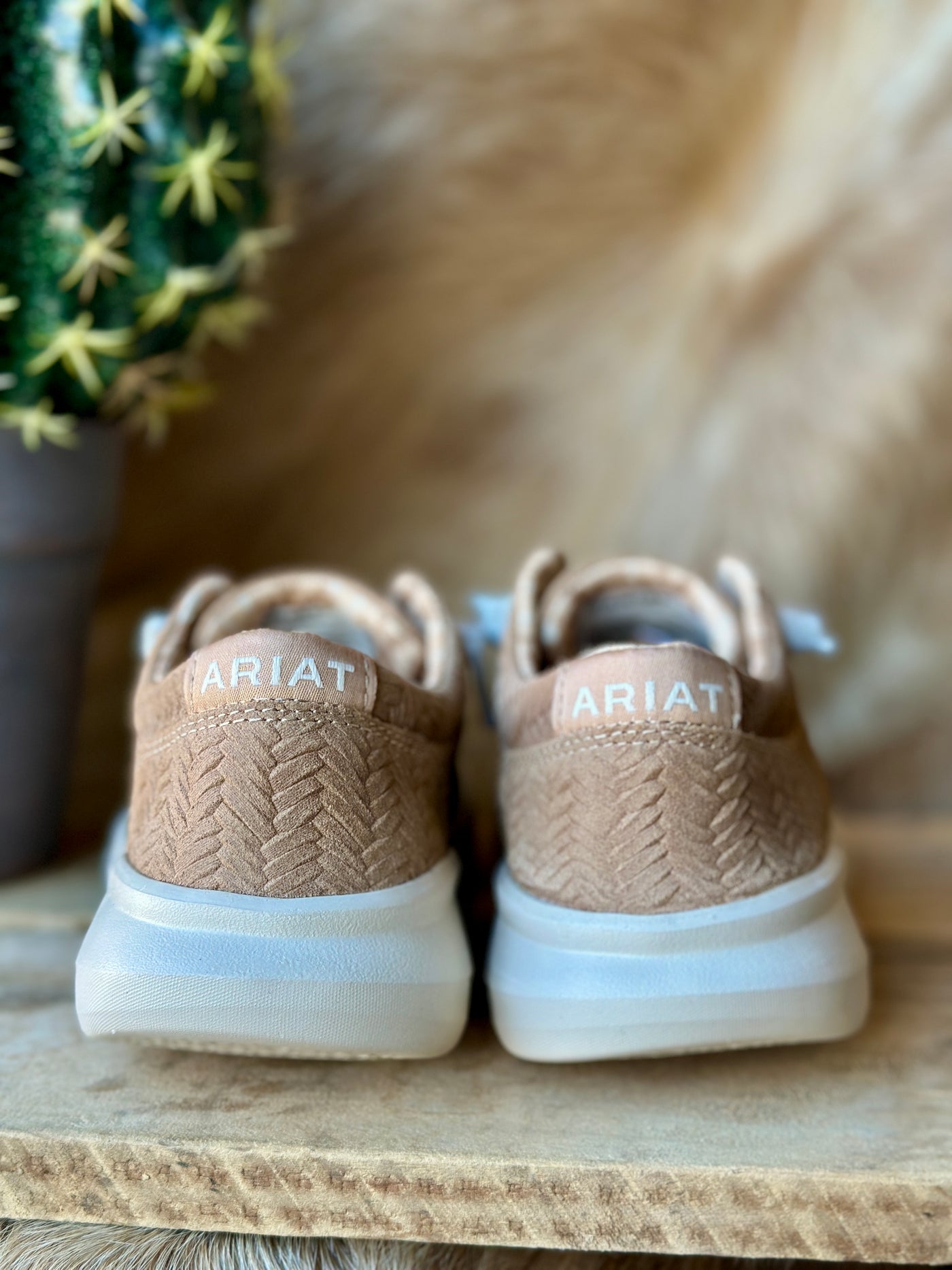 The Tan Woven Emboss Ariat Hilo Slip-On Shoe brings a fresh, textured twist to the slip-on shoe design for effortless style.