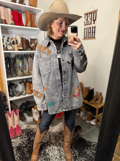Broker Leather model wearing Ariat Ella jeans tucked into cowgirl boots for a rodeo-ready look