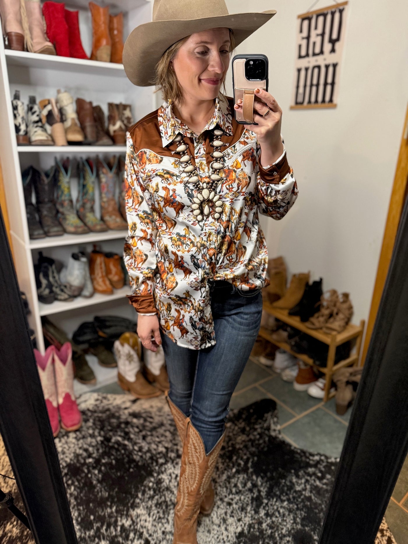 Model wearing Ariat Ella jeans tucked into cowgirl boots for a rodeo-ready look
