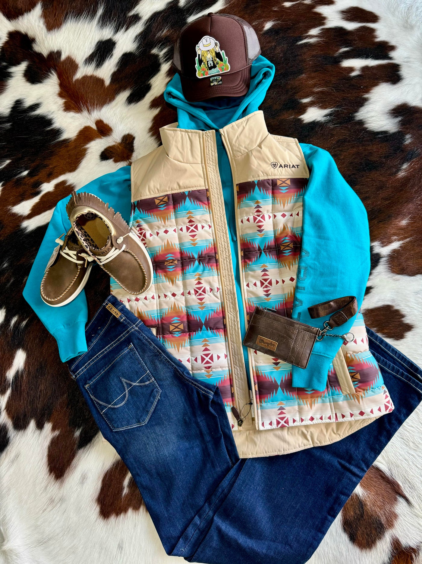 A Flatlay photo showing an outfit of jeans and shoes, featuring our Ariat Logo 2.0 Hoodie [Capri Breeze].