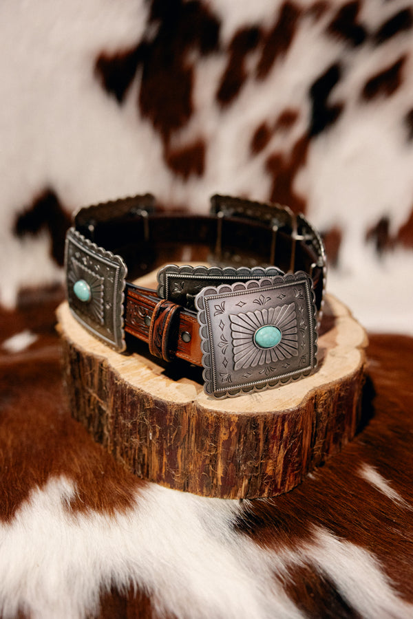 Side view of Ariat Tara Turquoise Concho Belt with detailed tooled leather design, sterling silver and turquoise accents.