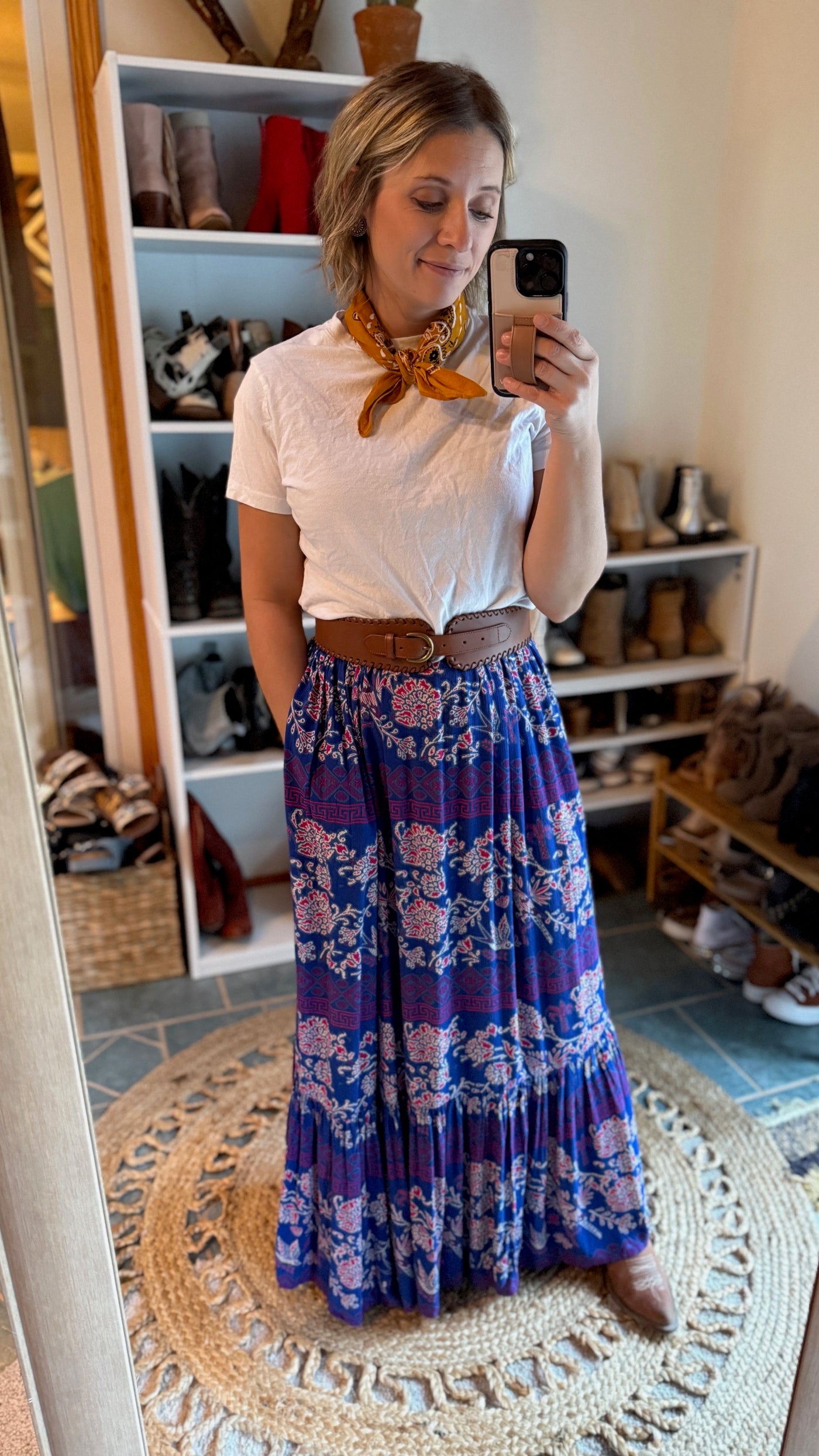 The Ariat Westley Candelia Print Dress outfit featuring a sleek leather corset belt, plain white tee, and a wild rag.