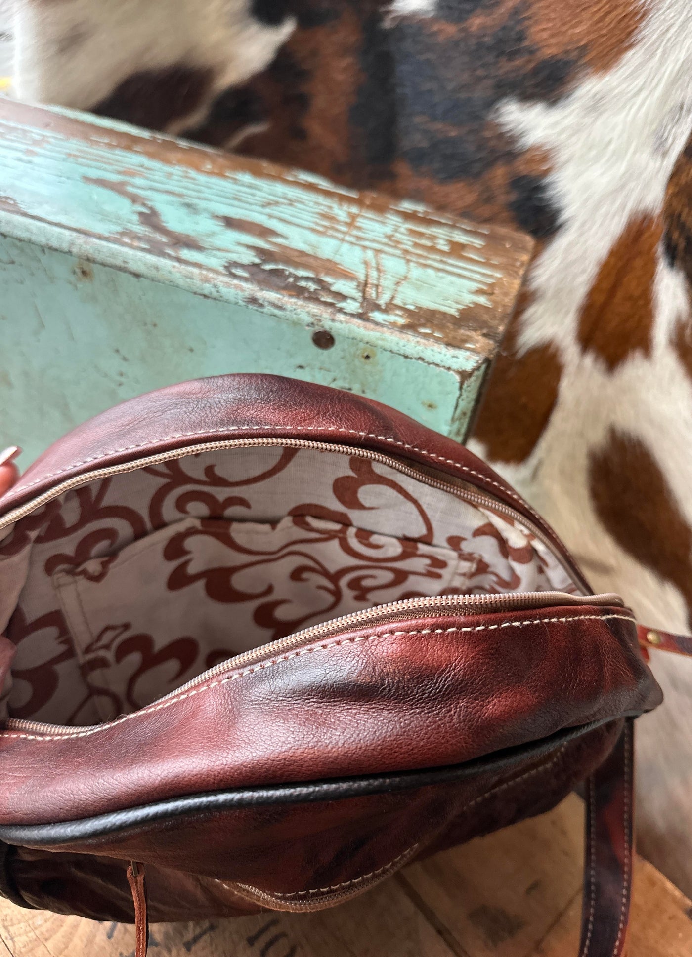 Interior view of the Arlene Crossbody Bag, featuring a zippered pocket for secure storage of essentials.