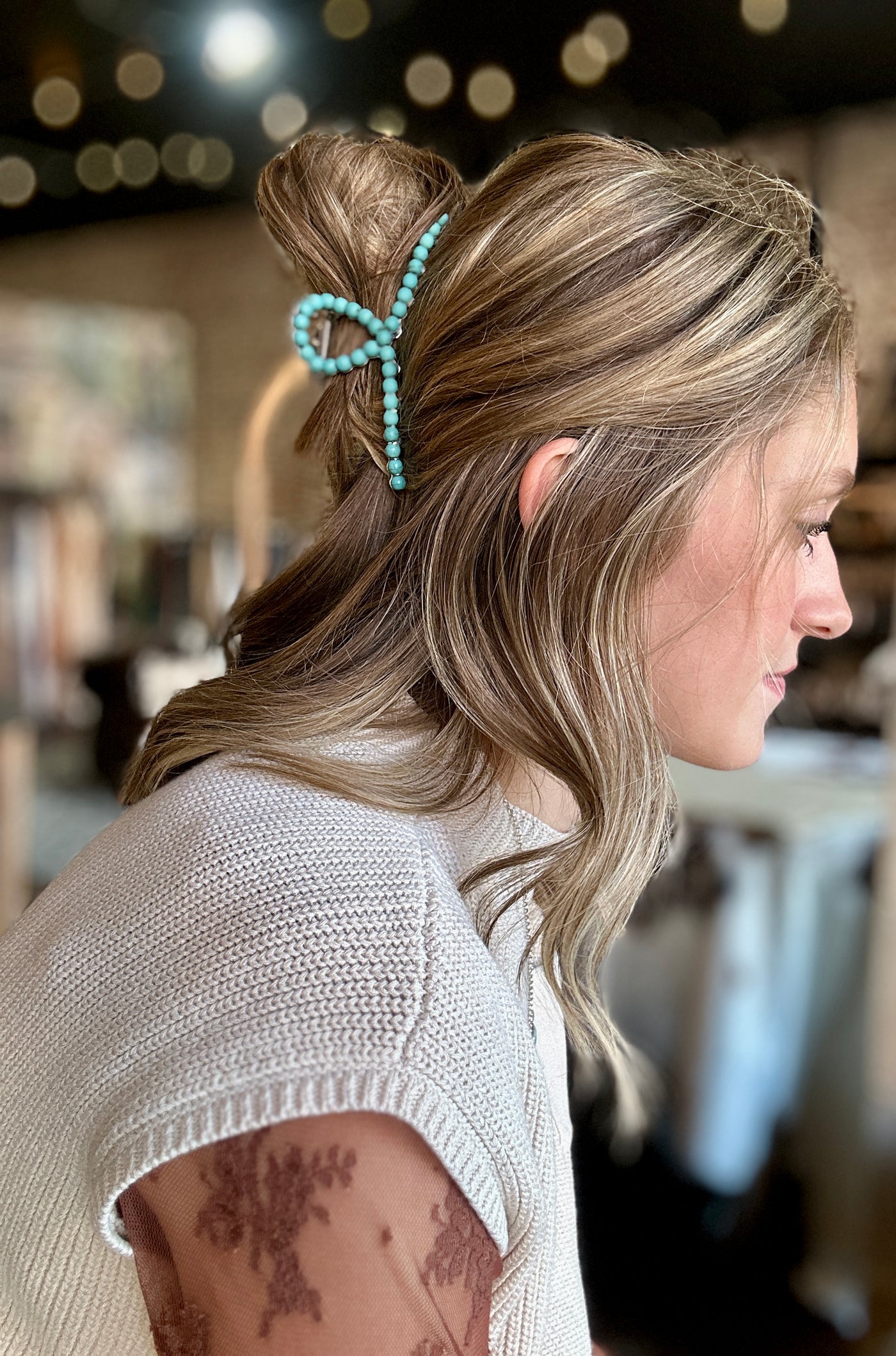 A woman modeling our Daylee Turquoise Bead Hair Claw Clip in her hair.