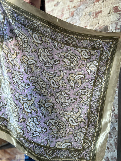 Photo showing the Beatrice Lavender & Tan Paisley Wild Rag held up to show the entire pattern across the scarf.