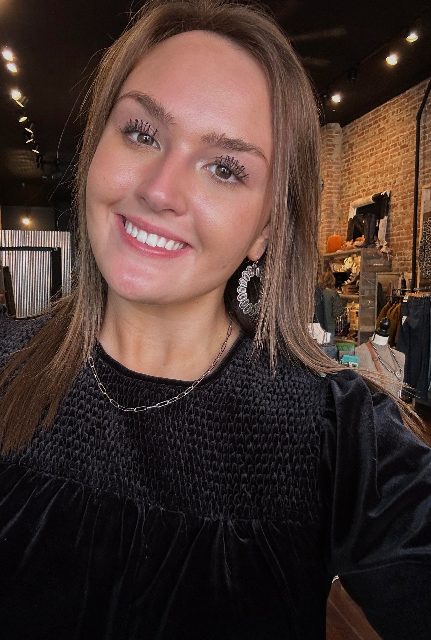 Picture of Broker Leather employee modeling our Believer Silver Concho Earrings.