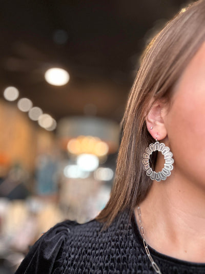 Picture of our Broker Leather Employee modeling our Believer Silver Concho Earrings.