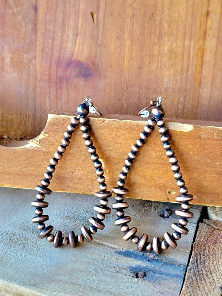 Nickel-free, lead-free, and chrome-free copper Navajo pearl earrings in a lightweight teardrop shape.