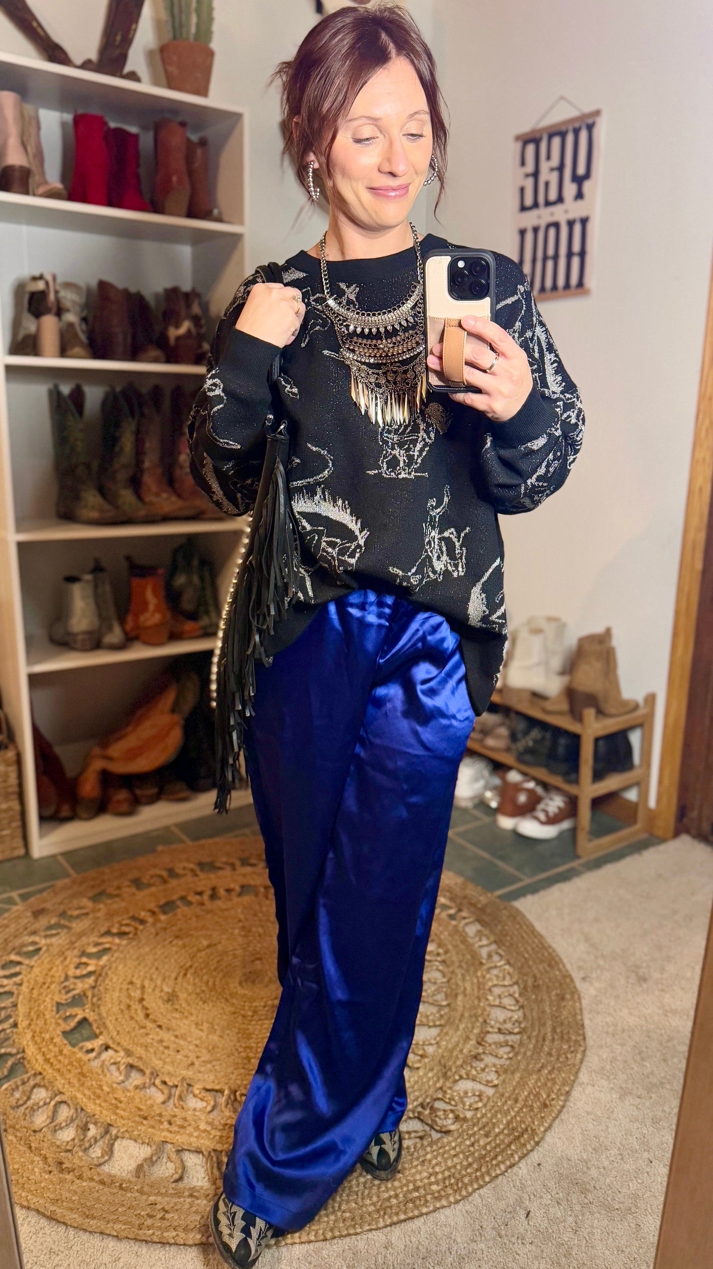 Broker Leather model, Brooke, stylishly put together the Brad Rodeo Metallic Sweater, with boots, a statement metal necklace and bright blue satin pants for an edgy, eye-catching look.