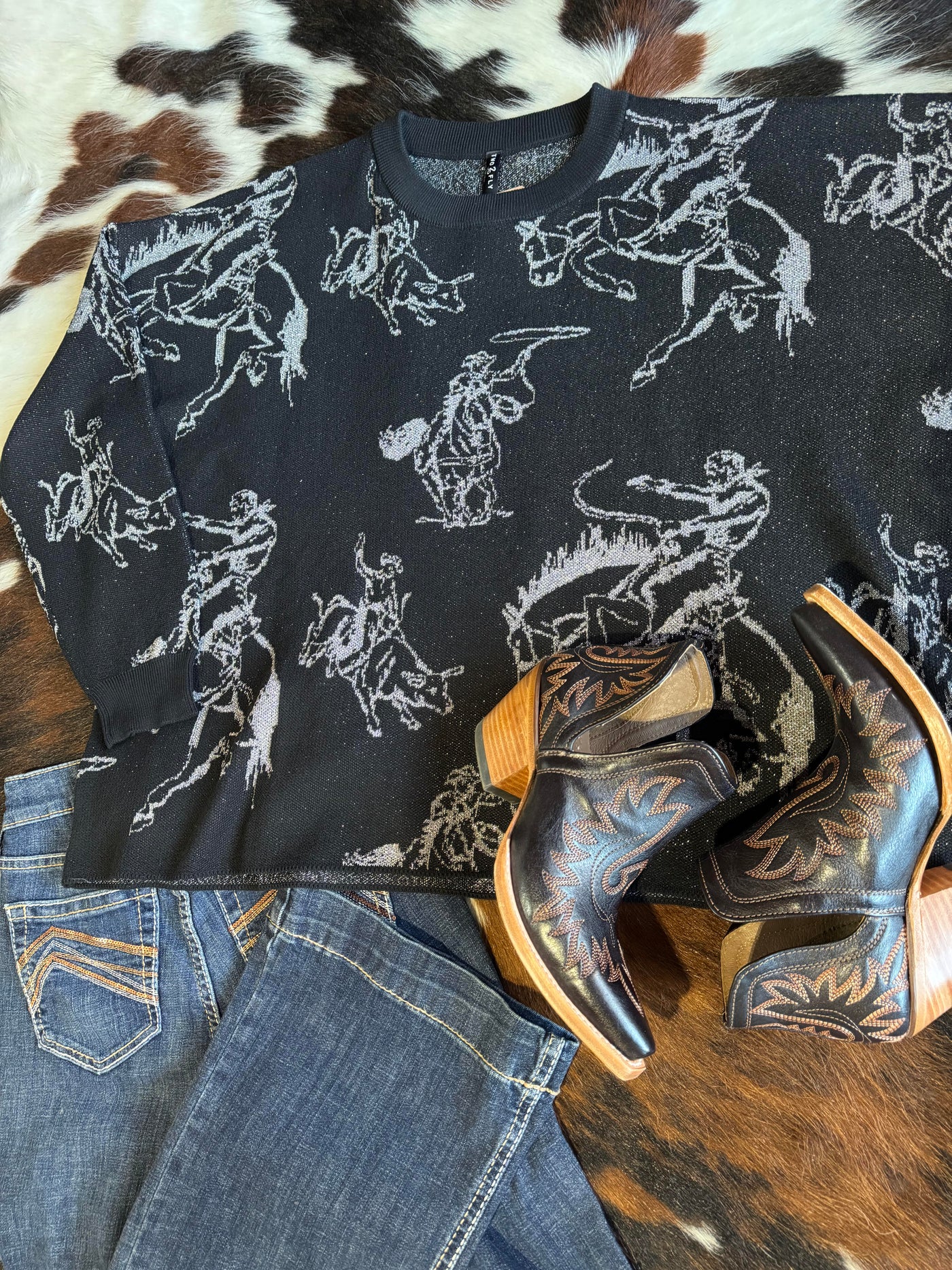 Feel stylishly put together with the Brad Rodeo Metallic Sweater, boots, and Ariat jeans.