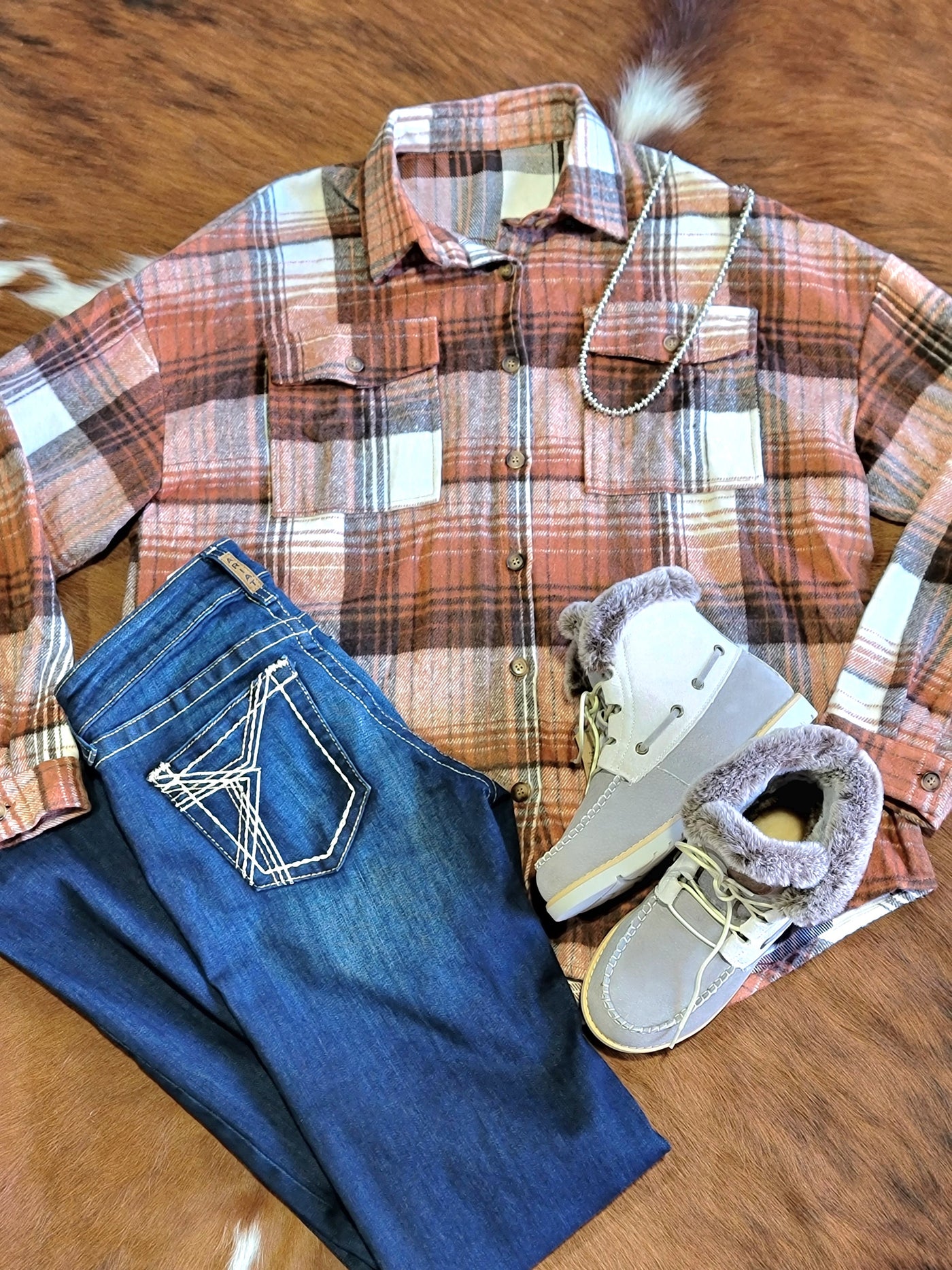 A classic plaid pattern and functional flap pockets, this Brandy Brown & Rust Plaid Shacket combines the structure of a jacket with the comfort of a shirt.