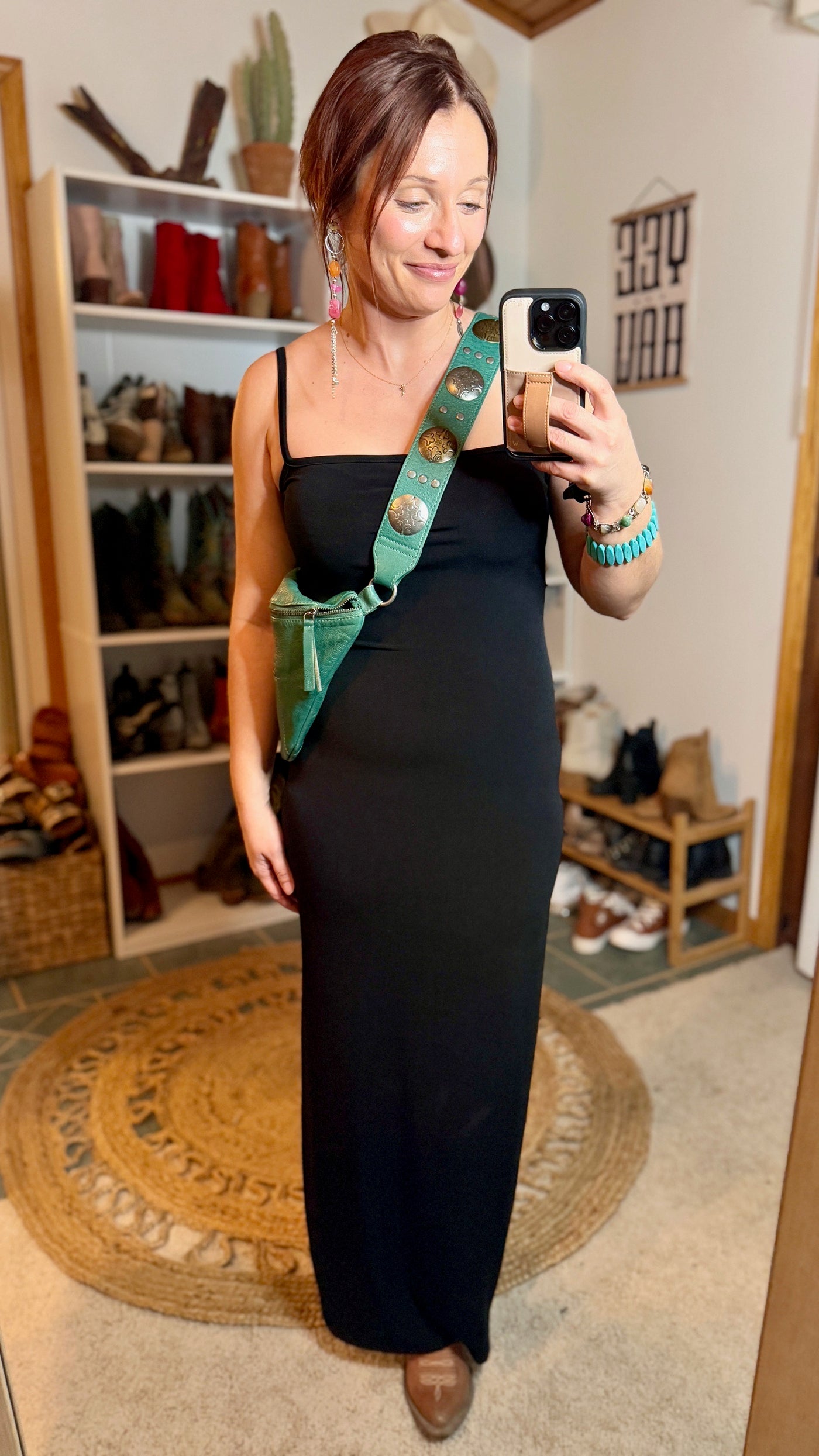 Elegant black maxi dress showcasing sleek spaghetti straps, perfect for moonlit rodeos.