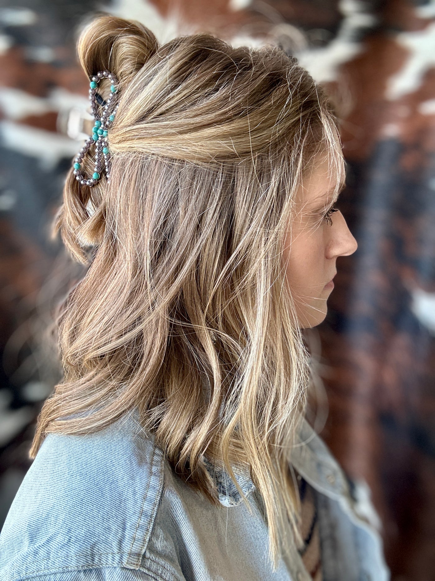 Model wearing Brenna Turquoise Bow Hair Claw Clip, adding a touch of sophistication and charm to her hairstyle.