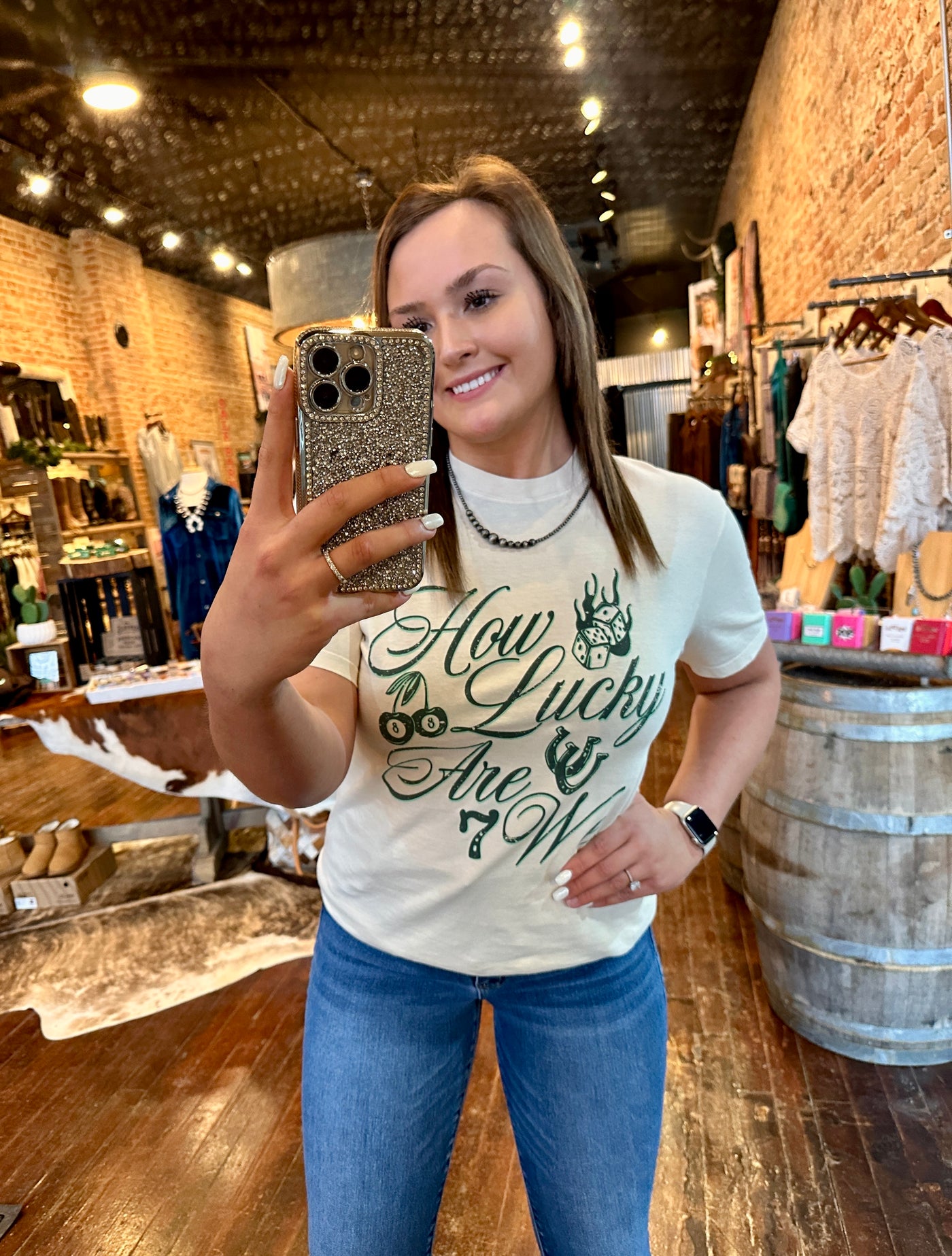 Model wearing the "Brianna How Lucky Are We" St. Patrick's Day tee, styled casually with denim and Navajo Pearls.