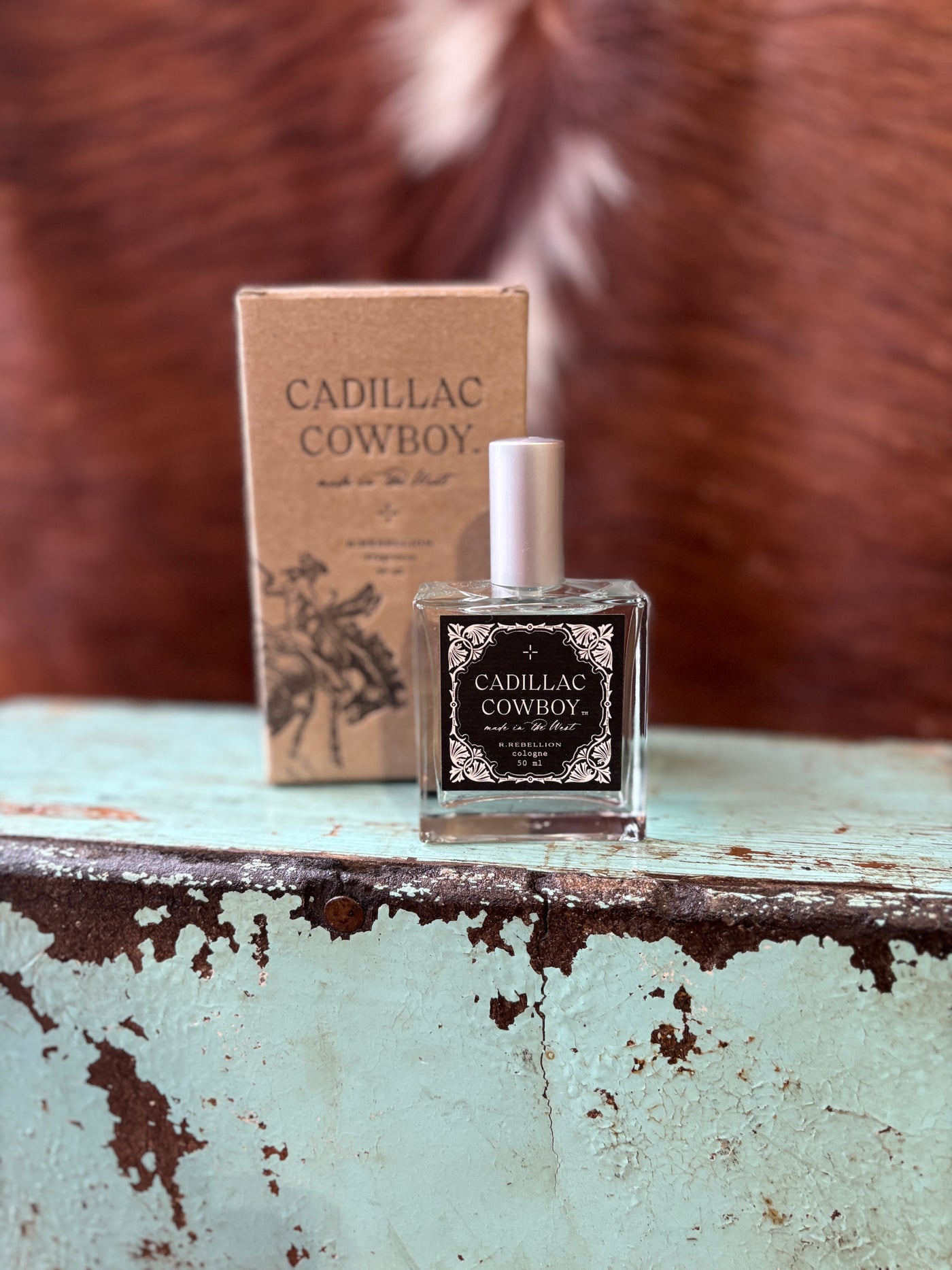 Cadillac Cowboy Cologne Spray in a 50 ml bottle, featuring bold notes of bergamot, citrus, jasmine, cardamom, musk, and sandalwood for a rugged yet refined scent.