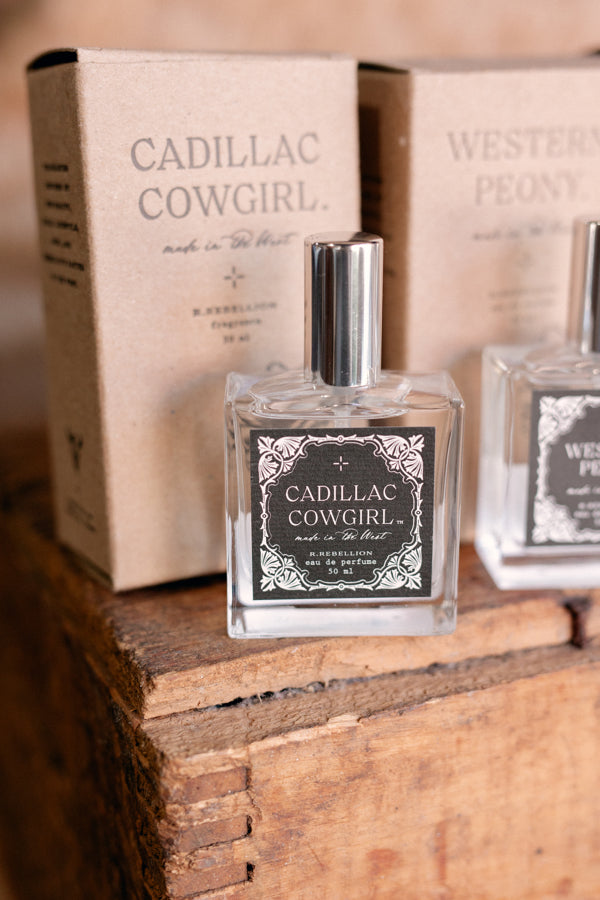 Photo of our glass bottle of Cadillac Cowgirl Perfume Spray with kraft box in background.