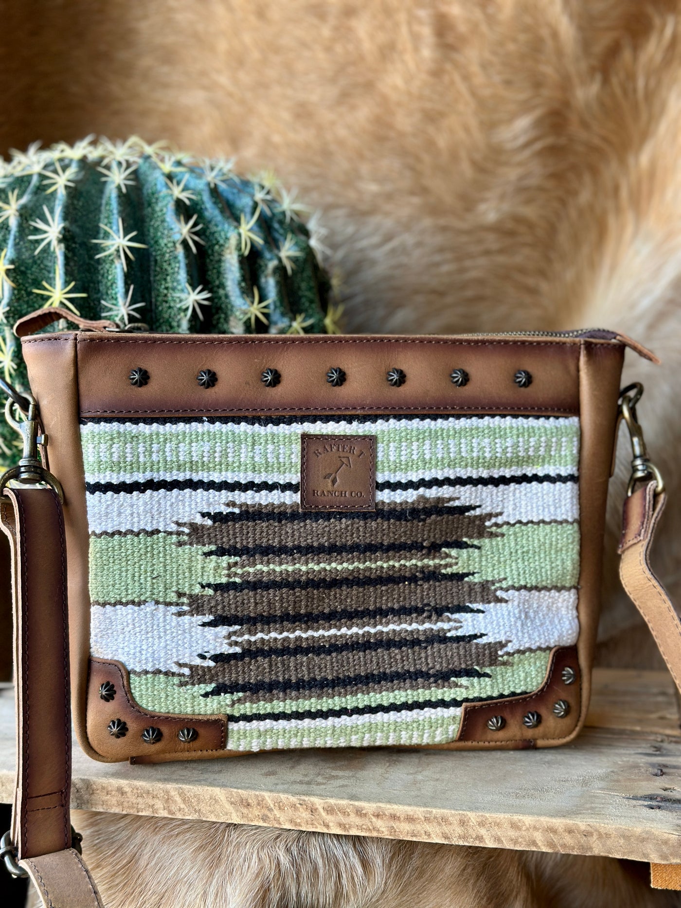 Calum Saddle Blanket Crossbody Bag featuring a secure zip closure and spacious interior for daily essentials.