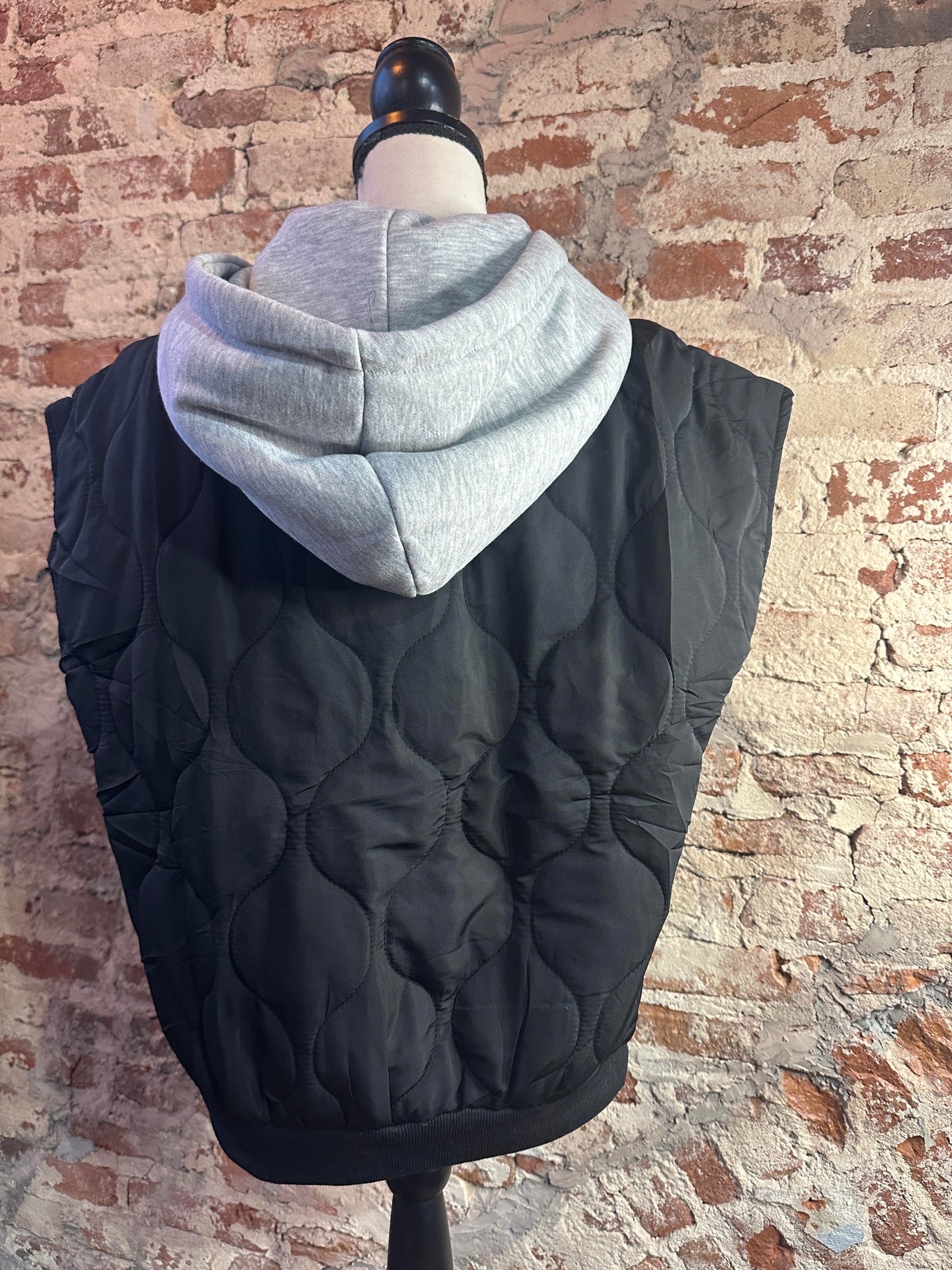 Mannequin photo showcasing the back side of our Celebrity Shot Quilted Vest [Black].