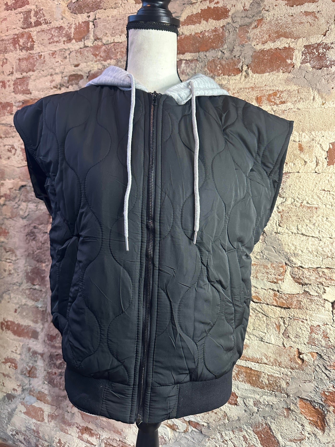 Mannequin photo showcasing the front side of our Celebrity Shot Quilted Vest [Black].