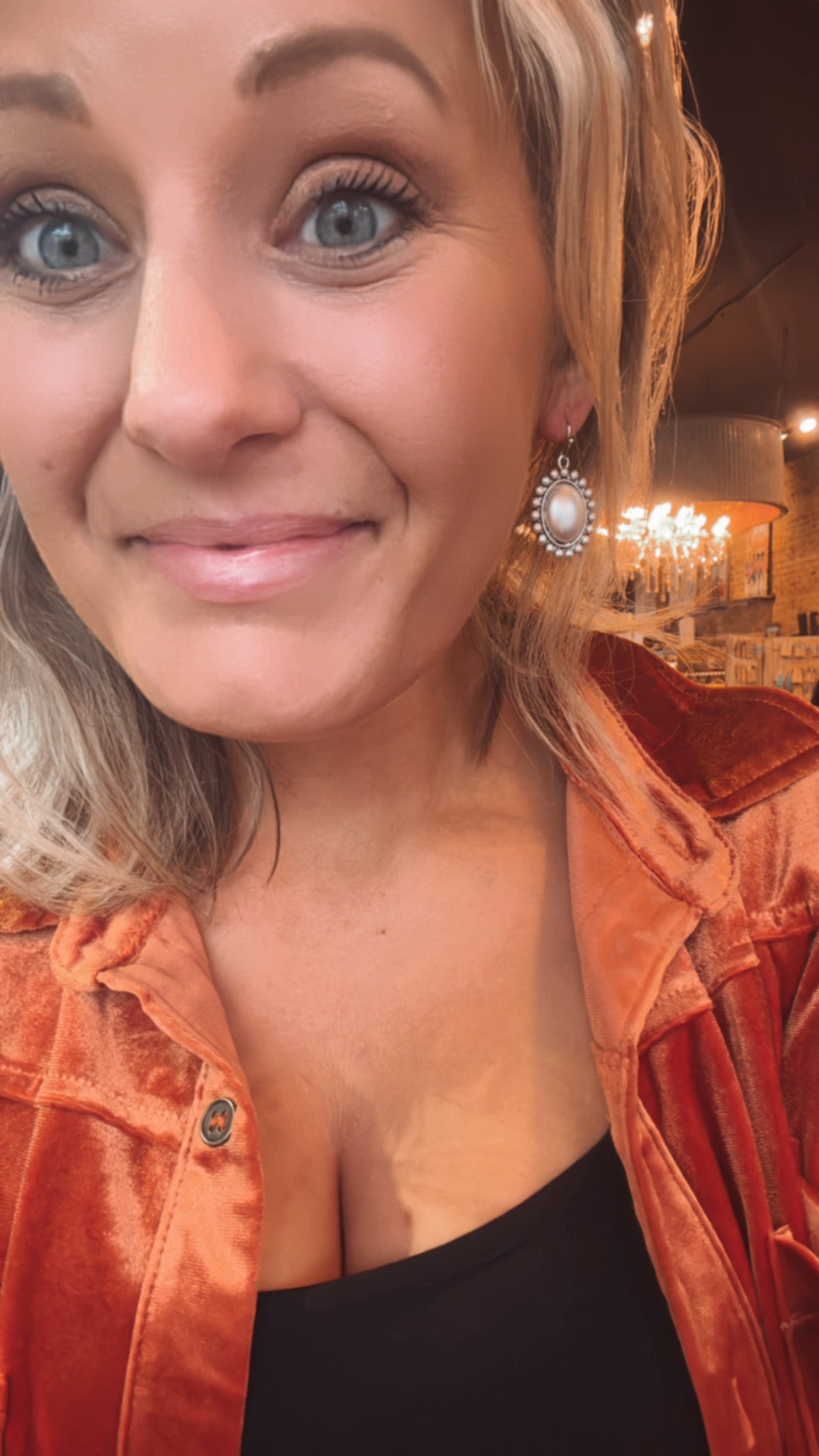 Woman modeling our Charlene Boho Oval Earrings to show size reference.