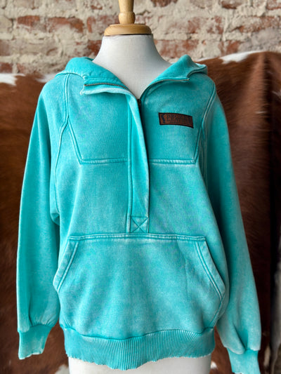 Front view of the Chin Up Champion Quarter Zip Sweatshirt in mineral washed turquoise, featuring a custom leather Broker Leather logo on the left chest.