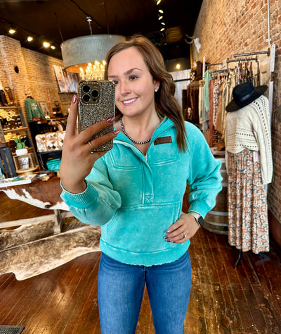 Gracelyn modeling the Chin Up Champion Quarter Zip Sweatshirt in a medium, showing a relaxed fit with a kangaroo pocket and quarter-zip neckline.