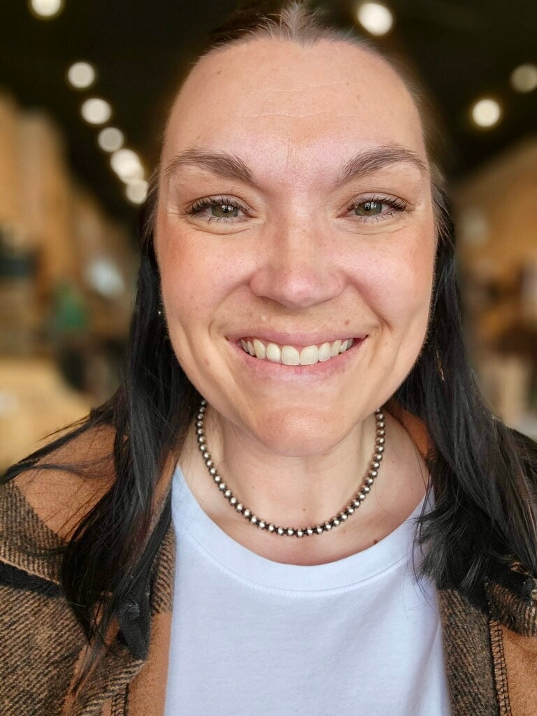 Cowgirl Chic Clara Navajo Pearl Necklace hand-strung with 6mm sterling silver pearls modeled by Broker Leather employee, Sam.