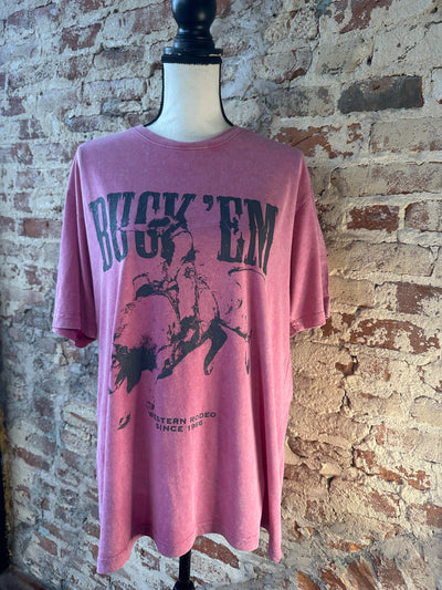 Front view of Clide Buck 'em Graphic Tee, featuring a humorous small-town-inspired quote, a bucking bull and soft pink fabric.