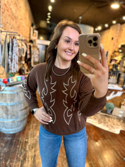 Brown boot-stitch pullover sweatshirt with a rustic western-inspired design.