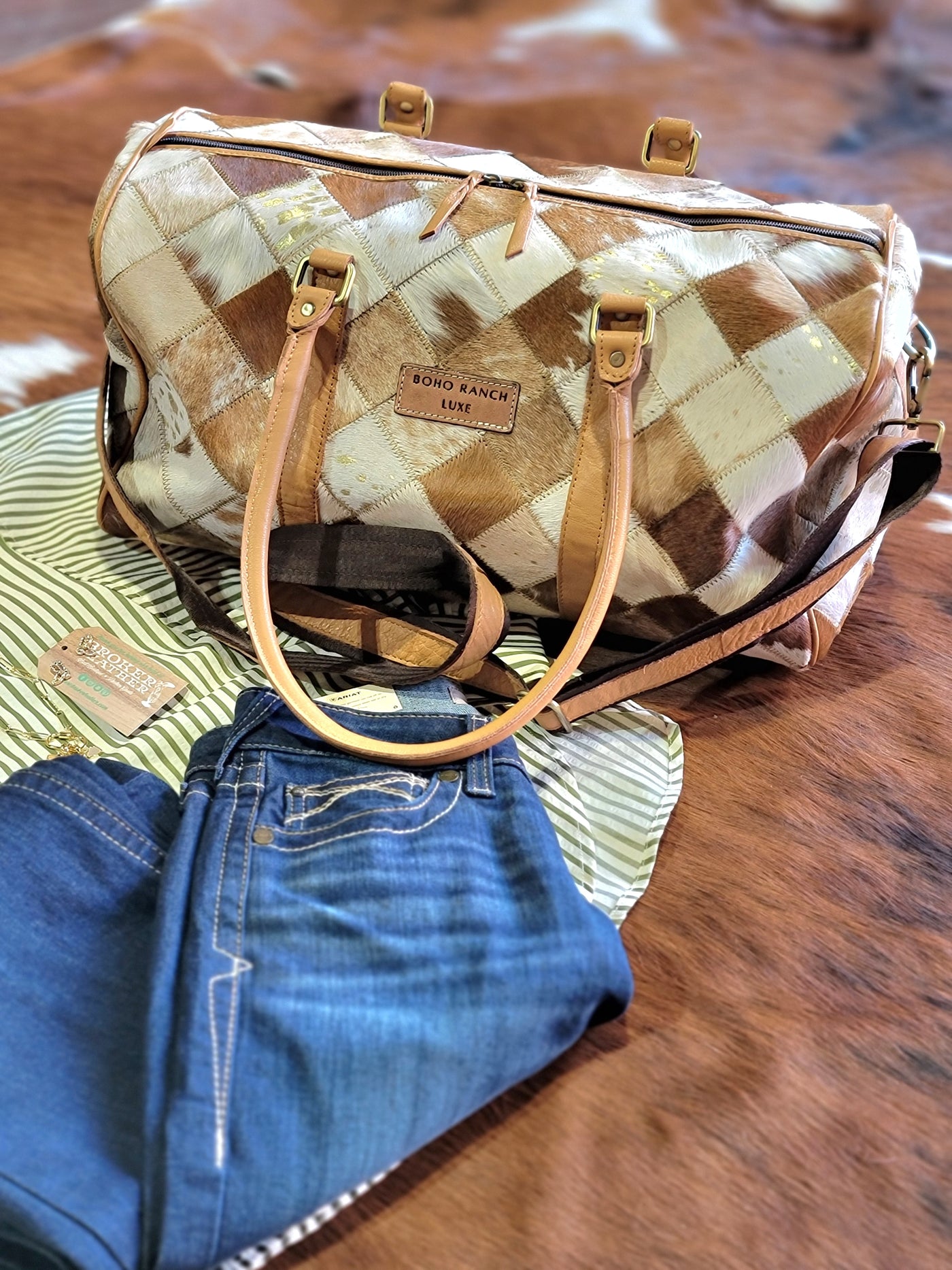 This Western-style travel bag featuring a unique checkered cowhide pattern paired with casual outfit at Broker Leather.