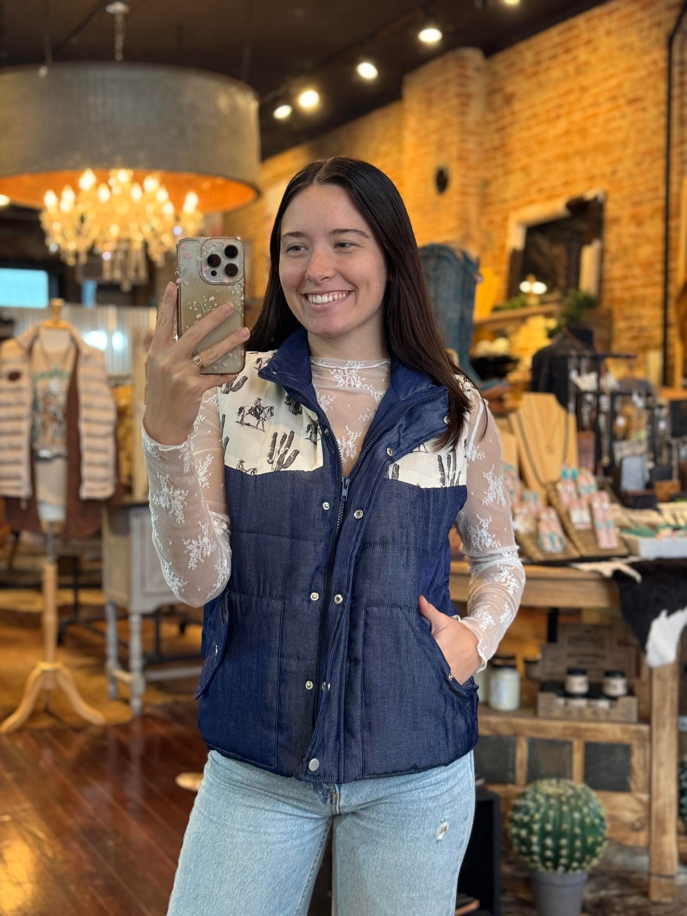 Model Aubree wearing the Cole Desert Print Vest, demonstrating the fit and practical features like hand-warming pockets.