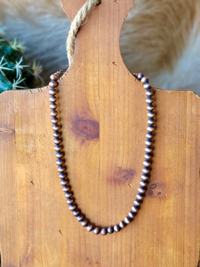 Rustic and elegant, this antique copper Navajo pearl necklace is designed for effortless cowgirl style.