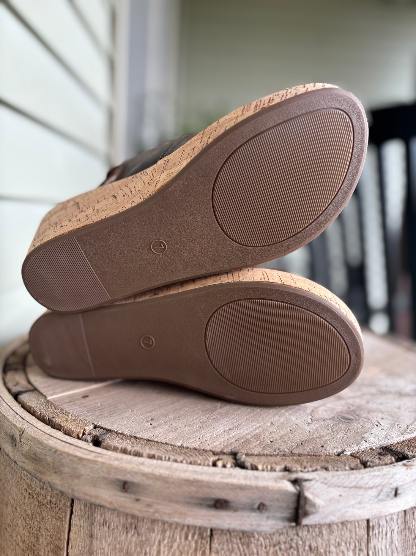 Brown shoes with cork soles on a wooden surface