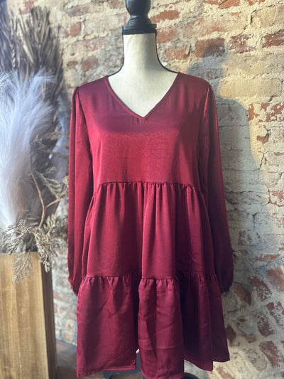 Perfect dress for fall events featuring a feminine tiered silhouette and ruffles.