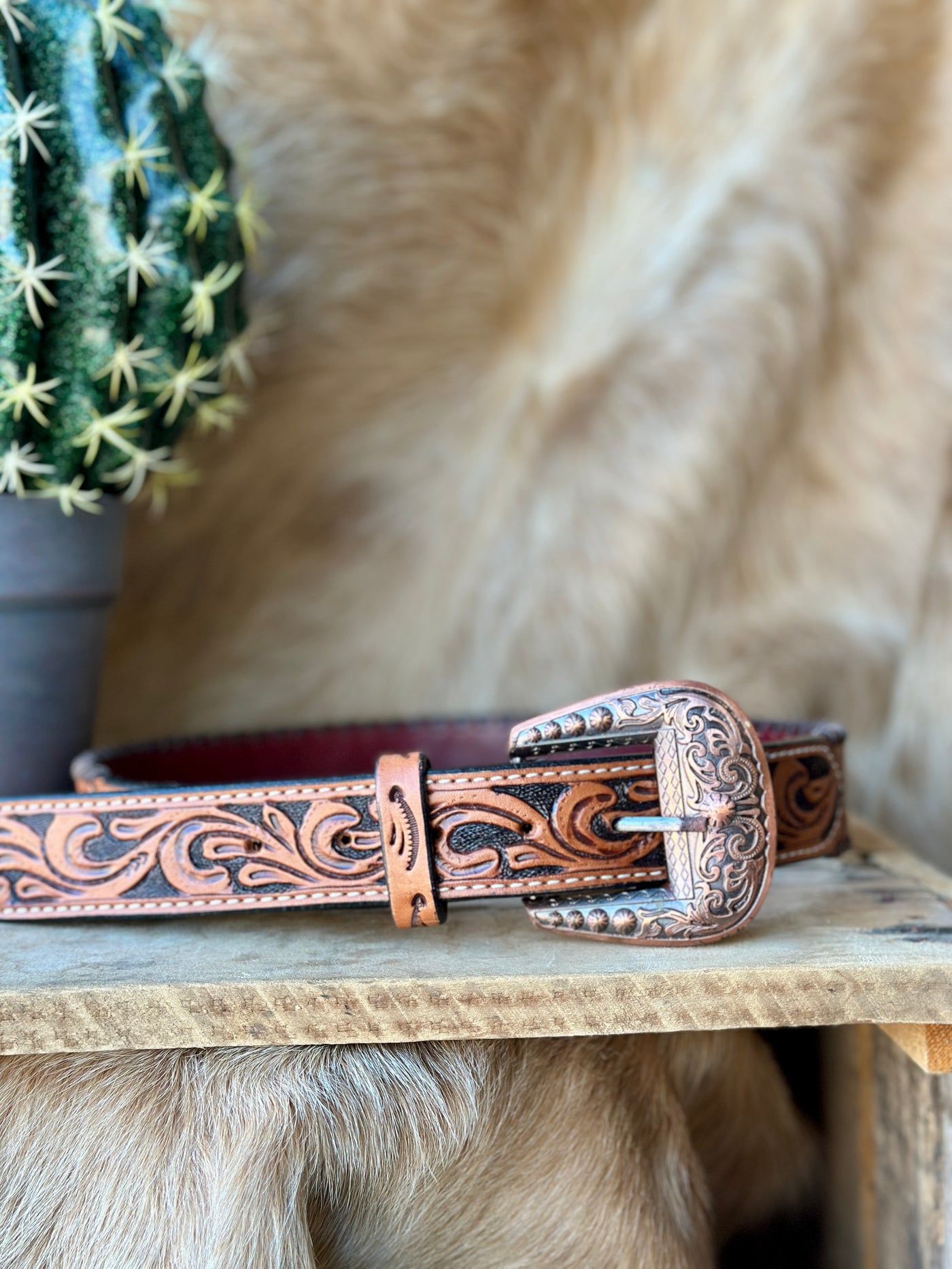 Tan Dahlia Tooled Leather Belt featuring hand-tooled floral patterns, copper buckle, and durable whipstitch detailing.